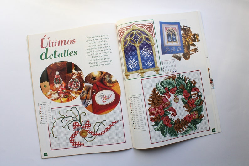 May include: A magazine page with a title that reads "&Uacute;ltimos detalles" and features several cross-stitch patterns. The patterns include a Christmas wreath, a window with snowflakes, and a Christmas tree ornament.