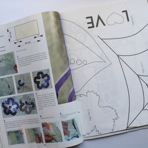 May include: A black and white craft project with instructions for making a flower and a spider web. The project includes a template for the flower and spider web, as well as instructions on how to cut and assemble the pieces. The project is titled "Fournitures" and includes the text "LOVE" and "Pages 14t 15" and "Pages 12 13".