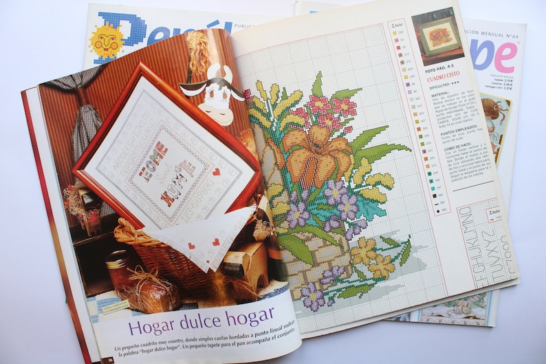 May include: A magazine page with a cross-stitch pattern for a floral design. The pattern is titled "Hogar dulce hogar" which translates to "Home sweet home".