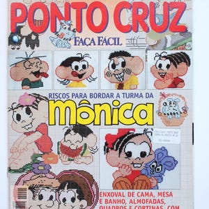 May include: A magazine cover featuring cross-stitch patterns. The title "Ponto Cruz" is in large red letters. Illustrations of cartoon characters are displayed, along with text in Portuguese. The magazine is for cross-stitch projects.