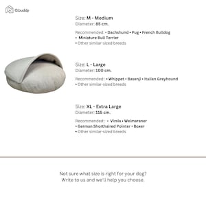 May include: A light gray dog bed with a hooded design. The image includes size recommendations for various dog breeds, with diameters of 85 cm, 100 cm, and 115 cm. Text on the image says, "Not sure what size is right for your dog? Write to us and we'll help you choose."