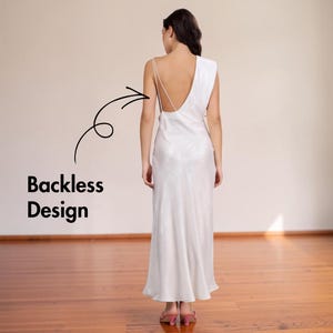 May include: A white, backless, floor-length dress with a draped shoulder detail. The dress has thin spaghetti straps and a flowing skirt. The text "Backless Design" is next to the dress.