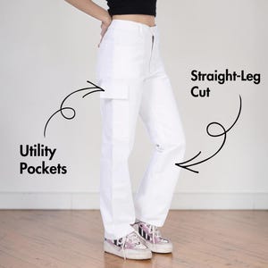 May include: High-waisted white pants featuring a straight-leg cut and utility pockets. The image includes black text labels pointing to the features, specifically reading Utility Pockets and Straight-Leg Cut, with black arrows indicating the details.