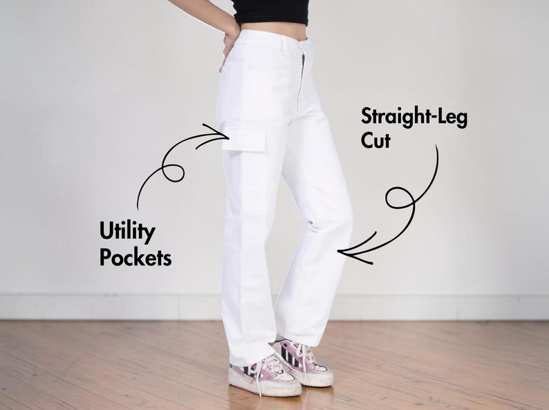 May include: High-waisted white pants featuring a straight-leg cut and utility pockets. The image includes black text labels pointing to the features, specifically reading Utility Pockets and Straight-Leg Cut, with black arrows indicating the details.