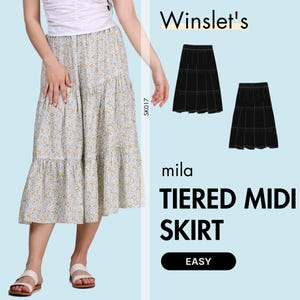 May include: A woman is wearing a floral print midi skirt with a tiered design. The skirt is white with a yellow floral pattern. The image also shows a black tiered skirt design and the text "Winslet's", "mila", and "TIERED MIDI SKIRT".