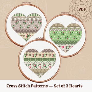 May include: Set of three cross stitch patterns featuring hearts with different floral and geometric designs in shades of green, brown, and white. The patterns are in PDF format.