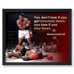 May include: A motivational quote by Muhammad Ali, "You don't lose if you get knocked down; you lose if you stay down." The quote is displayed on a black framed poster with a photo of Muhammad Ali in a boxing ring.