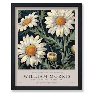 May include: A framed print of a vintage botanical illustration featuring white daisies with yellow centers against a dark blue background. The print includes the text "THE ARTISTRY OF 19TH CENTURY WILLIAM MORRIS COTTON PRINTS EXHIBITION HISTORY OF BRITISH DESIGN TEXTILES LONDON".
