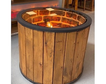 May include: A round wooden table with a glass top and a light bulb inside. The table is made of natural wood planks and has a black metal rim.