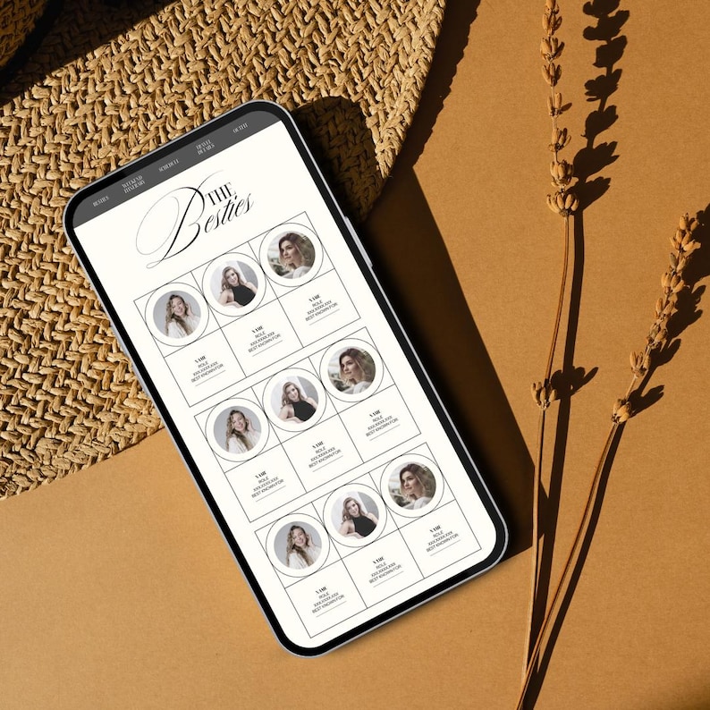 May include: A white smartphone displaying a social media page with the title "The Besties". The page features a grid of nine profile pictures of women, each with a white border and a small number below. The phone is lying on a brown surface with a woven straw hat and dried lavender stems.