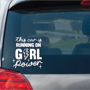 May include: White vinyl car sticker with the text "This car is running on girl power" with a lightning bolt graphic.