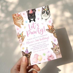 May include: A rectangular birthday invitation card featuring watercolor illustrations of cats wearing colorful party hats. The text reads Let's Pawty! Please join us to celebrate Olivia's 2nd birthday, Sunday, May 28th at 2:00 PM, Party Animals Nest, 1234 Animals Party Avenue, New York City, State, RSVP at 123-456-7890.