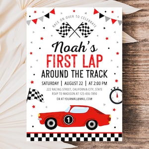 May include: A white rectangular invitation card featuring a red race car with the number one, checkered flags, and red and black bunting. The text reads Noah's FIRST LAP AROUND THE TRACK, Saturday August 22 at 2:00 PM, 222 Racing Street, California City.