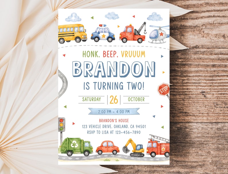 May include: A birthday invitation card featuring watercolor illustrations of a yellow school bus, police car, tow truck, helicopter, garbage truck, car, excavator, and fire truck. Text reads: HONK. BEEP. VRUUUM BRANDON IS TURNING TWO! SATURDAY 26 OCTOBER.