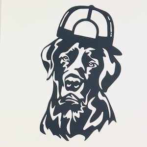 May include: Black and white silhouette of a Labrador Retriever wearing a baseball cap. The dog is looking directly at the viewer.