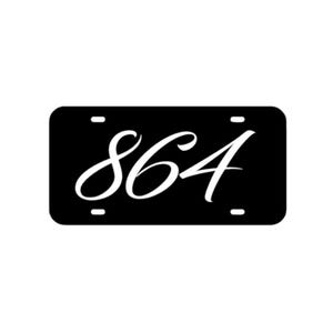 May include: Black license plate with white cursive text that reads "864".