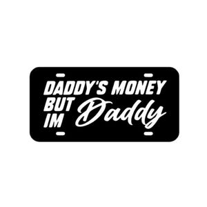 May include: Black and white license plate design with the text "Daddy's Money But Im Daddy".