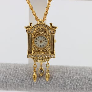 W. Lind 14KGE Japan Quartz Cuckoo Watch Pendant or Brooch with Chain Detailed Decoration with Rhinestones and Scroll Work 1970s