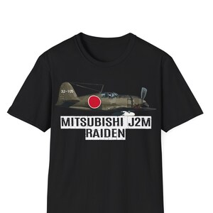 May include: Black t-shirt with a graphic of a Mitsubishi J2M Raiden fighter plane with a red circle on the fuselage. The text "MITSUBISHI J2M RAIDEN" is printed in white below the plane.
