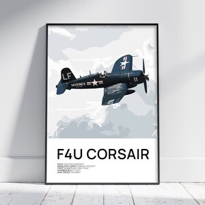 May include: Framed print featuring a dark blue F4U Corsair fighter aircraft in flight against a light blue and white cloudy background. The text "F4U CORSAIR" is displayed below the image, along with aircraft details. The print is in a black frame.