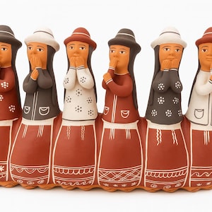 May include: A ceramic sculpture of six figures in traditional dress. Each figure wears a hat and has their hands near their face. The figures are in various colours, including red, white, and brown. The base is terracotta with white decorative patterns.