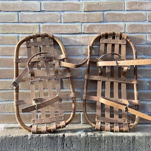 Old vintage mountain snowshoes in wood & French leather Old ski chalet decoration Snowshoes