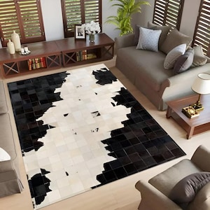 May include: A rectangular area rug with a striking black and white patchwork design. The rug features a geometric pattern with a mix of square and rectangular shapes, creating a modern and stylish look. The color scheme is a bold contrast.