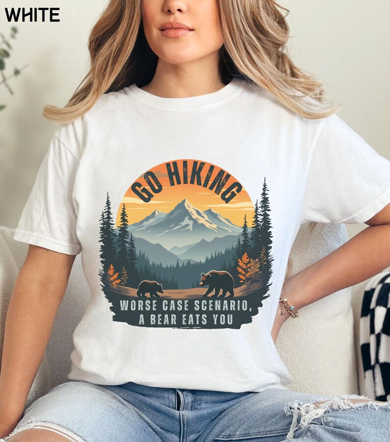 May include: White t-shirt with a graphic of a mountain range and two bears. The graphic says "Go Hiking" and "Worse Case Scenario, A Bear Eats You".