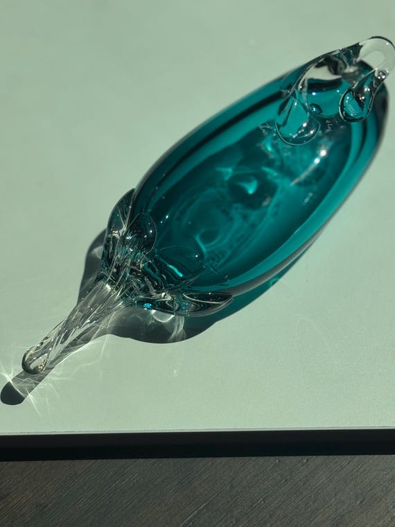 A signed, handmade blown glass sculpture by Lisa Rhomberg in that instantly-recognizable Tiffany aqua — the kind of one-off art object that becomes a shelf centerpiece forever.