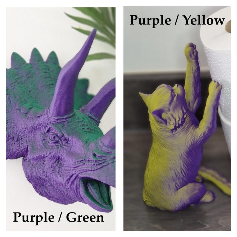 May include: Two 3D printed figurines, one of a purple and green dinosaur and one of a purple and yellow cat. The dinosaur is a Triceratops with a large horn on its nose and two smaller horns above its eyes. The cat is standing on its hind legs with its front paws raised. The text "Purple / Green" is below the dinosaur and "Purple / Yellow" is below the cat.