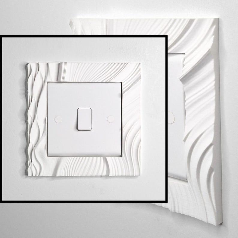 May include: A white light switch plate cover featuring a textured, wavy, and rippled relief pattern surrounding a central square switch. The design consists of smooth, flowing lines that create a three-dimensional effect on the rectangular frame.