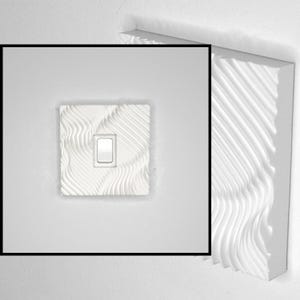 May include: A white light switch cover plate featuring a textured, wavy, three-dimensional pattern across its entire surface. The square plate surrounds a single, centered, rectangular white rocker switch toggle, creating a tactile design.