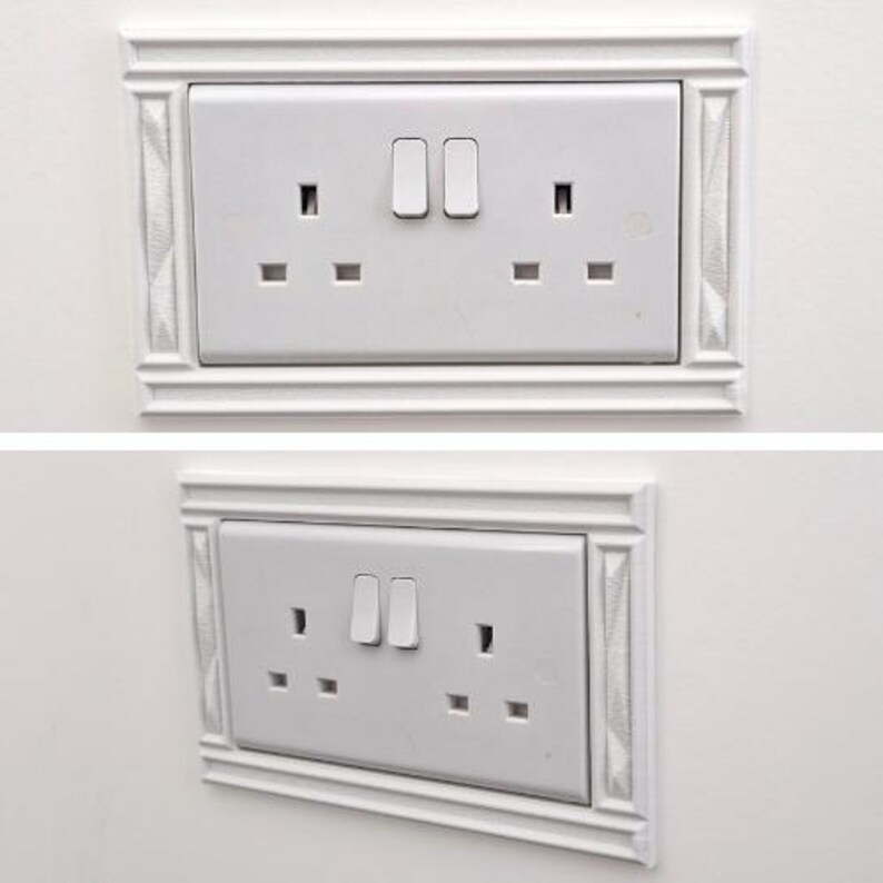 May include: A white double electrical wall outlet with two switches, featuring a decorative rectangular frame with textured side panels. The outlet has a standard three-prong configuration for each socket, presented in both a front and angled view.