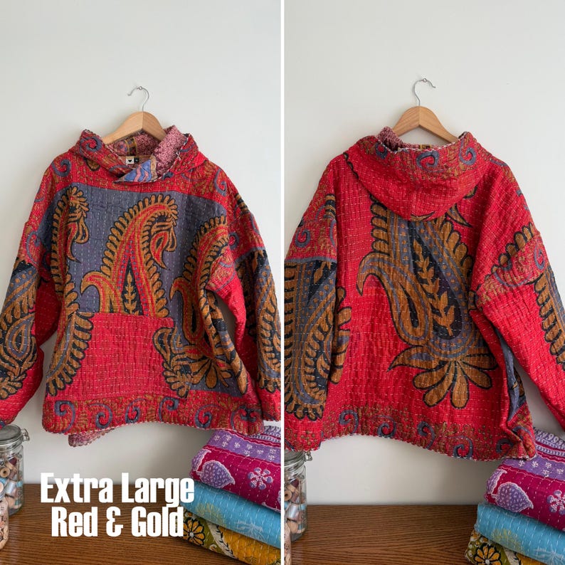 May include: Extra large red and gold hooded jacket with paisley design. The jacket is made of quilted fabric and features a hood and long sleeves. The text "Extra Large Red & Gold" is visible in the image.