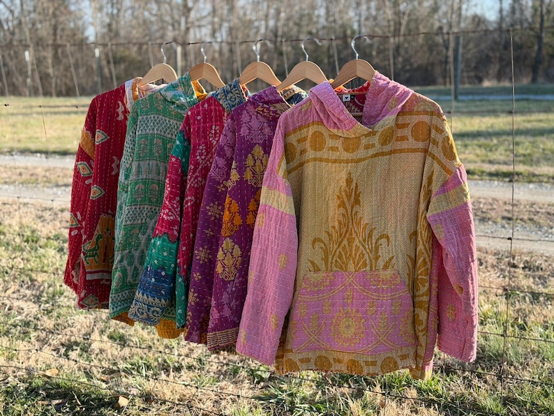 May include: A white ceramic mug with a black handle and the text "But First, Coffee" in a black, bold font. The mug is sitting on a wooden surface. The mug is approximately 4 inches tall.