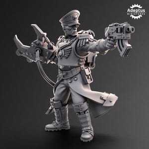 May include: A grey miniature figure of a military officer, wearing a peaked cap and long coat, holding a mechanical claw and a futuristic gun. The figure has detailed armour and is posed in a dynamic stance. The Adeptus Miniatures logo is in the upper right corner.