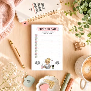 May include: A notepad with the text "COPIES TO MAKE" and a cartoon illustration of a woman. The notepad is surrounded by a pen, a cup of coffee, and stationery items. The notepad also has the text "PLAN AHEAD. STAY PREPARED. YOU'VE GOT THIS!"