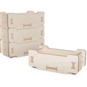 May include: Stackable wooden storage crates. The crates are made of light-colored wood and feature a rectangular design with cut-out handles. One crate is separate, while others are stacked. Each crate has a series of interlocking joints.