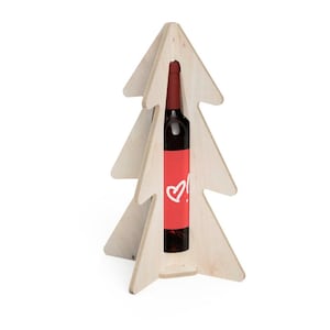 May include: A wooden Christmas tree-shaped wine bottle holder. The holder is made of light-colored wood and has a bottle of red wine inside. The wine bottle has a red label with a white heart symbol.