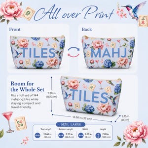 May include: A light blue zippered pouch featuring an all-over print of pink peonies, blue hydrangeas, hummingbirds, mahjong tiles, and martini glasses. The front displays the text TILES, the back displays MAHJ, and it measures 12.60 in by 7.28 in by 3.15 in.