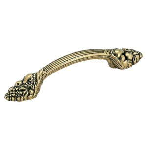May include: A decorative cabinet pull handle with a bronze finish. The handle has a curved design with a detailed grape cluster and leaf motif on each end. The center of the handle has a ribbed texture.