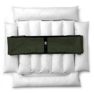 May include: A dog bed set featuring a white, quilted base and bolster pillows. The set includes a dark green, rectangular cover with a black strap and a logo. The bed is designed for pet comfort and support.