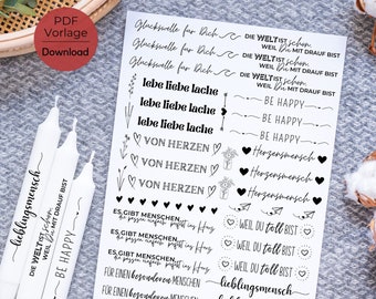 May include: A sheet of black and white stickers with various phrases and designs. The phrases include "Die Welt ist schon", "Weil mit drauf bist", "Be Happy", "Von Herzen", "Herzensmensch", "Weil du toll bist", and "Lieblingsmensch".