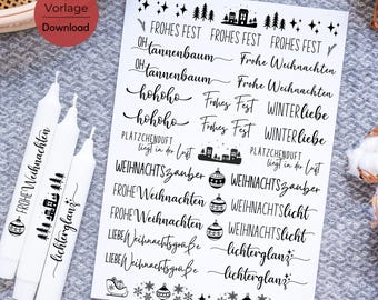 May include: A sheet of black and white Christmas stickers with various festive phrases and images, including "Frohe Weihnachten", "Winterliebe", "Weihnachtszauber", "Lichterglanz", and "hohoho".