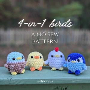 May include: Four crocheted bird toys in different colors: blue, yellow, white, and blue. The birds are sitting on a green wooden surface. The text "4-in-1 birds A NO SEW PATTERN @lilsloveys" is visible on the surface.
