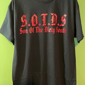 May include: Black t-shirt with a red graphic that says "S.O.T.D.S. Son Of The Dirty South"
