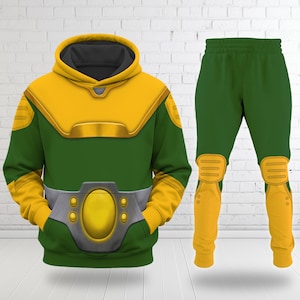 May include: A green and yellow hooded sweatshirt and matching sweatpants set. The hoodie features a yellow hood, shoulder panels, and a central belt graphic with a metallic gray buckle. The pants have yellow knee pads and lower leg sections.