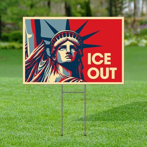 May include: A yard sign featuring a stylized image of the Statue of Liberty in red, blue, and cream colors. The words "ICE OUT" are printed in cream-colored block letters. The sign is mounted on a metal frame and set in green grass.