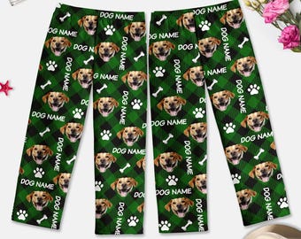 May include: Green and black pajama pants with a repeating pattern of a dog's face, bone, and paw print. The text "DOG NAME" is repeated throughout the pattern.