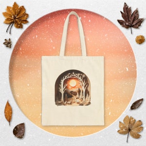 A sunset scene in the winter wonderland tote bag. Enchanted forest design in paper art style. Unisex tote bag.